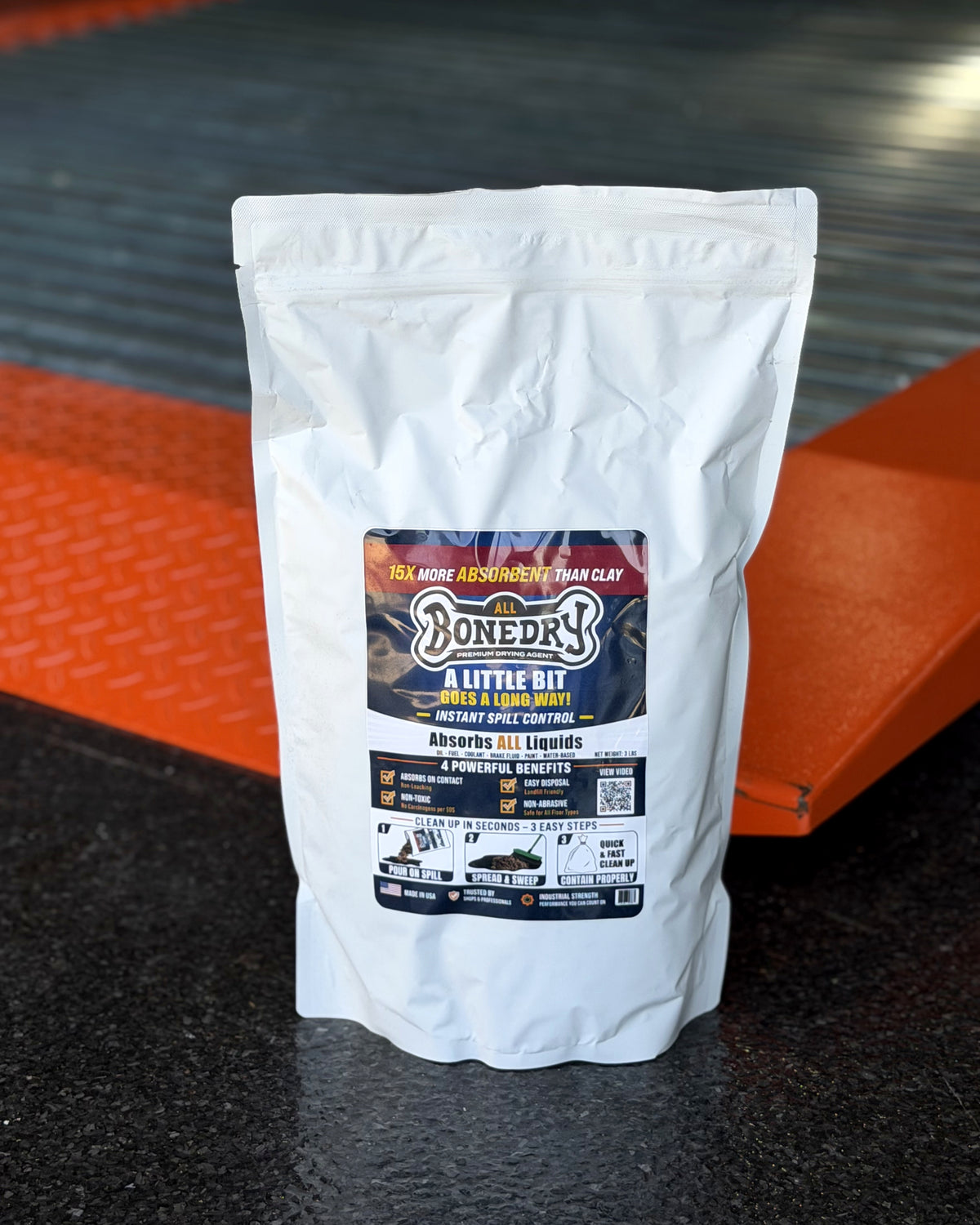 BoneDry ALL 3 lb resealable spill absorbent in a homeowner garage on an automotive lift — sold as a case of 6