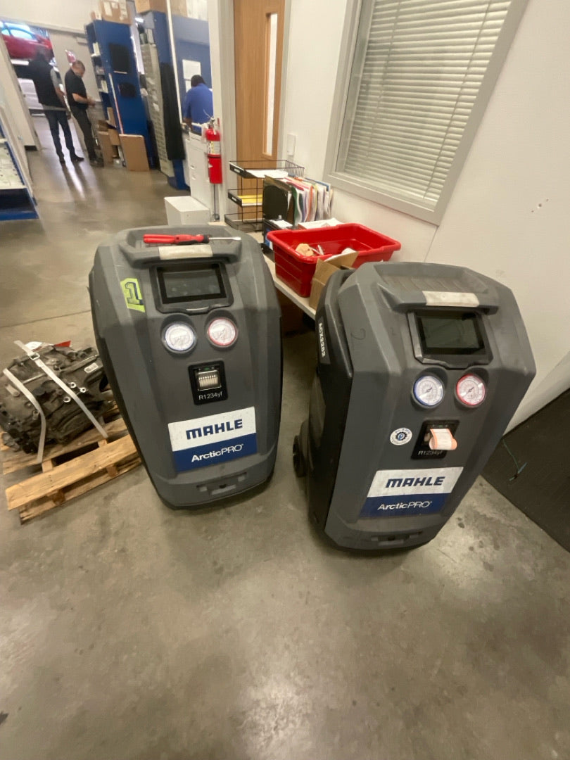 Multiple automotive A/C recovery and recharge machines serviced by Alamo Equipment at a commercial dealership